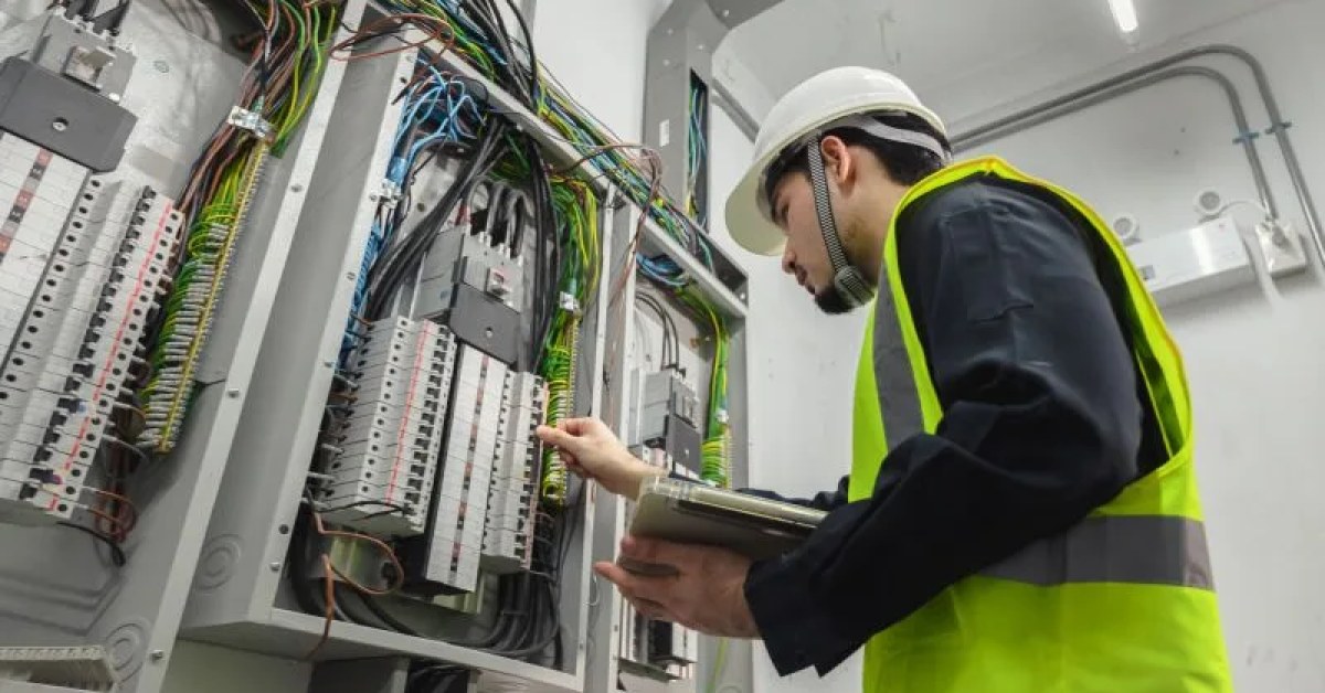 Electrician examining an electrical circuit during troubleshooting